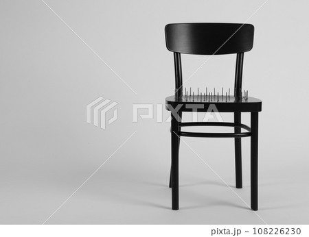 Chair with iron nails isolated on white. Hemorrhoids concept 108226230