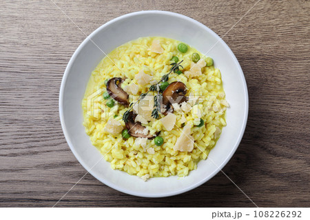 Delicious risotto with cheese and mushrooms on wooden table, top view Delicious risotto with cheese and mushrooms on wooden table, top view 108226292