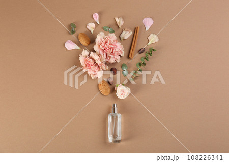 Flat lay composition with bottle of perfume on light brown background 108226341