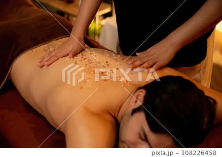 Man customer having exfoliation treatment in luxury spa. Quiescent Man customer having exfoliation treatment in luxury spa. Quiescent 108226458