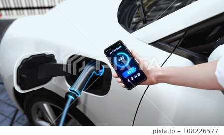 Smartphone display battery status interface by smart EV app. Peruse Smartphone display battery status interface by smart EV app. Peruse 108226577