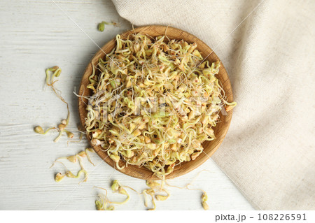 Plate with sprouted green buckwheat on white wooden table, flat lay Plate with sprouted green buckwheat on white wooden table, flat lay 108226591