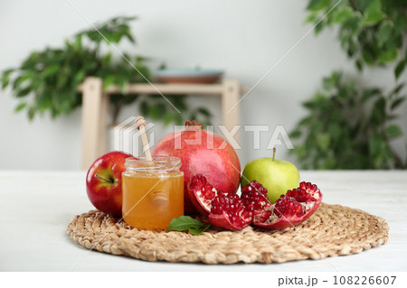 Honey, apples and pomegranate on white wooden table. Rosh Hashanah holiday Honey, apples and pomegranate on white wooden table. Rosh Hashanah holiday 108226607