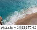 Turkish Sea, top view. Kaputas Beach in Turkey. Beautiful waves roll over the sandy beach. Blue sea and yellow sand. Beach near the town of Cash in Turkey. Copy space 108227542