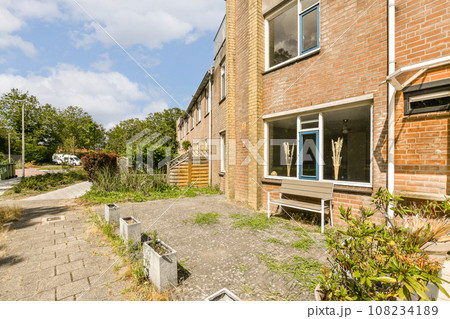 an outside area with some plants and bushes in the fore - eyed view, as seen from another side window 108234189