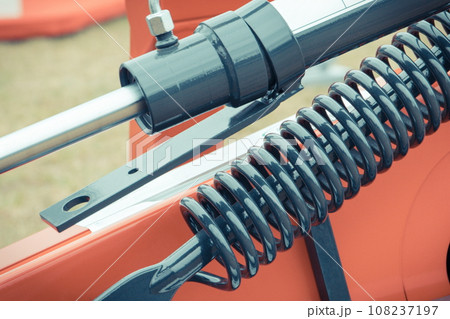 Black piston or actuator and steel spring in red pneumatic or hydraulic machine. Technology Black piston or actuator and steel spring in red pneumatic or hydraulic machine. Technology 108237197