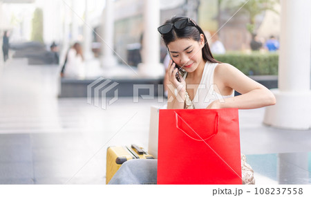 Asian woman relax on vacations buying and shopping with happy smile face. Asian woman relax on vacations buying and shopping with happy smile face. 108237558
