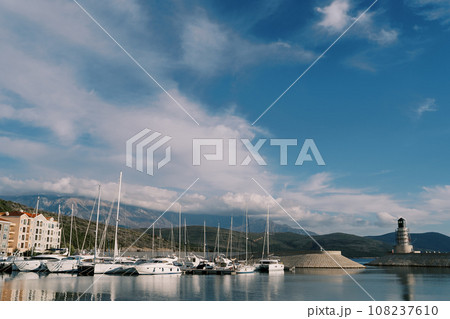 Row of sailing yachts are moored at Lustica Bay near the lighthouse. Montenegro 108237610