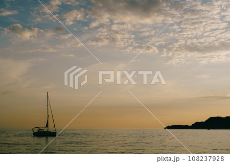 Sailing yacht sails on the sea at sunset Sailing yacht sails on the sea at sunset 108237928