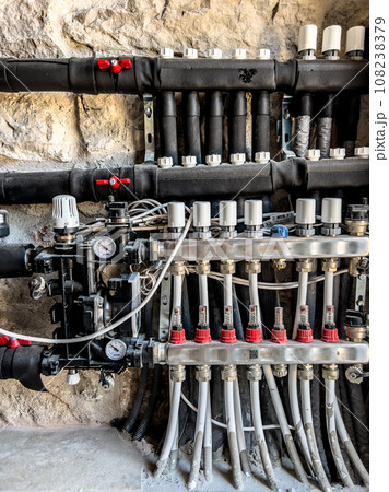 Mixing heat supply unit with taps and sensors on the wall of the building 108238379