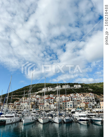 Sailing yachts are moored off the coast with colorful houses. Lustica Bay, Montenegro 108238488
