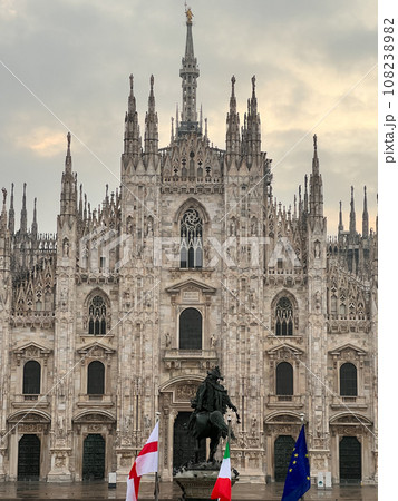 Statue of King Victor Emmanuel II in front of the Duomo Cathedral against a cloudy sky. Milan, Italy Statue of King Victor Emmanuel II in front of the Duomo Cathedral against a cloudy sky. Milan, Italy 108238982