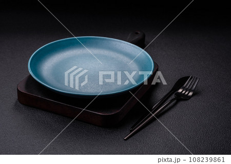 Beautiful empty round ceramic plate on a concrete background Beautiful empty round ceramic plate on a concrete background 108239861