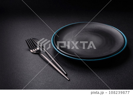 Beautiful empty round ceramic plate on a concrete background 108239877