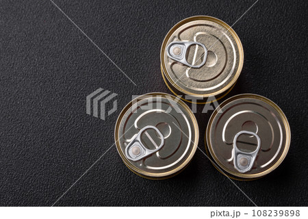 Round metal can with canned fish or meat with a key 108239898