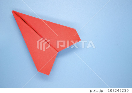 Top view of red paper airplane on blue background with customizable space for text. Copy space and plane concept. 108243259