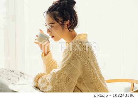 カフェで新聞を読みながら談笑する女性 108243396