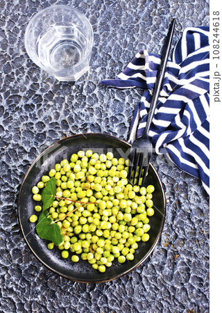 Green peas in the black bowl 108244618