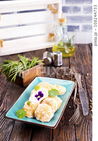 Chicken patties or fish cakes fried in breadcrumbs with ketchup 108244733