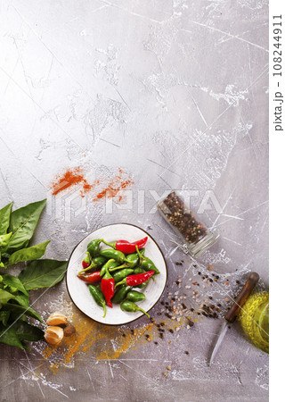 Red and green Chillies on white plate 108244911
