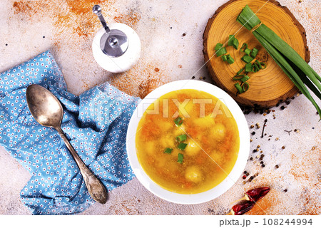 Pea soup with pieces of bacon and parsley in a bowl on white background. Selective focus 108244994