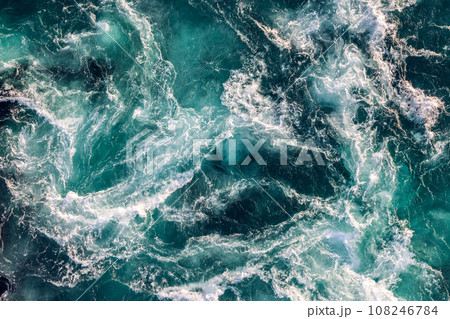 Blue waves of water of the river and the sea meet each other during high tide and low tide. Blue waves of water of the river and the sea meet each other during high tide and low tide. 108246784