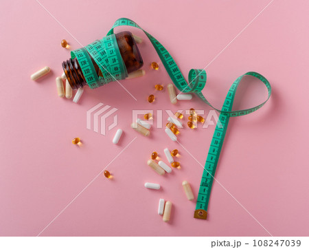 Weight Loss Pills and Measuring Tape, Diet Supplements Capsules, Obesity Lose Tablets, Color Drugs Pile Weight Loss Pills and Measuring Tape, Diet Supplements Capsules, Obesity Lose Tablets, Color Drugs Pile 108247039