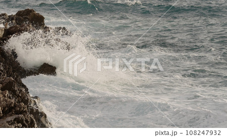 sea waves crushing over rocks with soft light 108247932