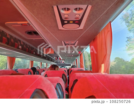 Group of tourist sitting in the bus and looking through the bus windows Group of tourist sitting in the bus and looking through the bus windows 108250726