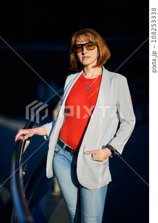 Close-up Portrait of Stylish Redhead Woman in Urban Autumn Fashion 108253338