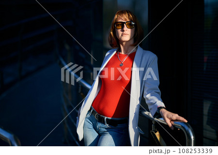 Close-up Portrait of Stylish Redhead Woman in Urban Autumn Fashion 108253339