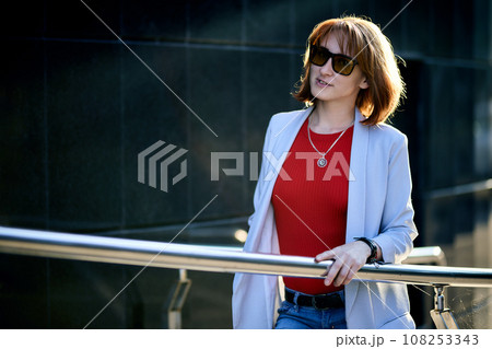 Close-up Portrait of Stylish Redhead Woman in Urban Autumn Fashion 108253343