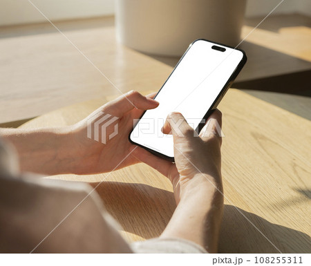 Berlin, Germany October 20 2023 Hands holding mobile phone mockup, texting with fingers 108255311