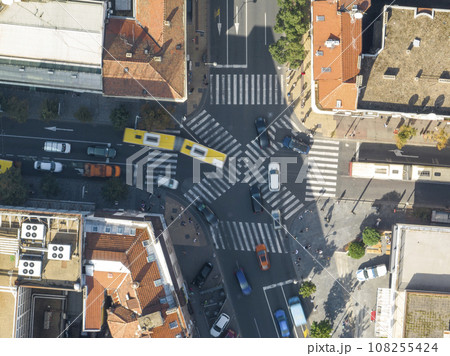 Top view over a crowd pedestrian crossing road intersection, Belgrade. Aerial view od traffic at busy scramble crosswalk Top view over a crowd pedestrian crossing road intersection, Belgrade. Aerial view od traffic at busy scramble crosswalk 108255424