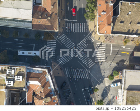 Top view over a crowd pedestrian crossing road intersection, Belgrade. Aerial view od traffic at busy scramble crosswalk Top view over a crowd pedestrian crossing road intersection, Belgrade. Aerial view od traffic at busy scramble crosswalk 108255425