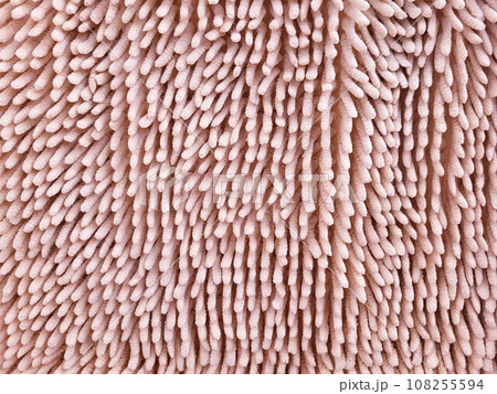 The texture of a pink furry carpet. Abstract background. The texture of a pink furry carpet. Abstract background. 108255594