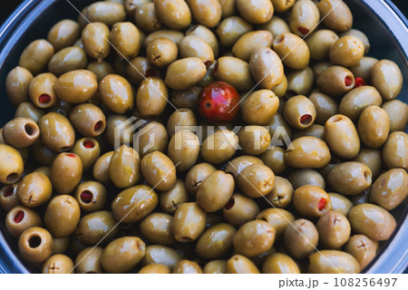 The olive Olea europaea is the fruit of the olive tree. Green olives on market. The olive Olea europaea is the fruit of the olive tree. Green olives on market. 108256497