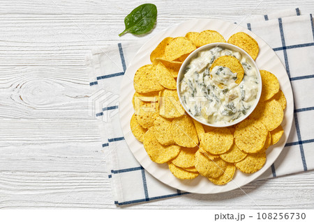 artichoke spinach almond dip with potato chips 108256730
