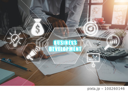 Business development concept, Business team analyzing income charts and graphs on office desk wiht business development icon on virtual screen. 108260146