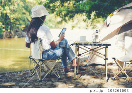 Camping outdoor. Asian women camping leisure and destination travel near waterfall. 108261698