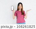 Smiling asian woman holding smartphone with blank screen for advertise on white background. 108261825