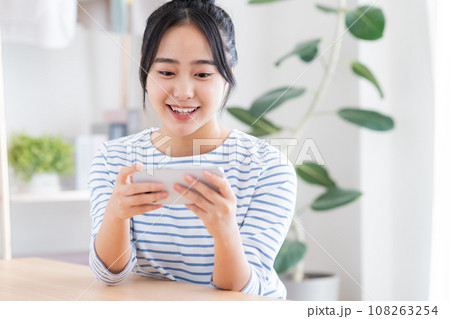 スマホで動画を見る若い女性 スマホで動画を見る若い女性 108263254