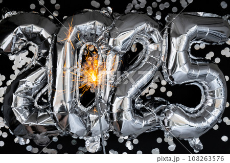 Happy new year 2025 metallic balloons with confetti and sparkler firework Bengal lights on dark black background. Greeting card silver foil balloons numbers Christmas holiday concept. Celebration Happy new year 2025 metallic balloons with confetti and sparkler firework Bengal lights on dark black background. Greeting card silver foil balloons numbers Christmas holiday concept. Celebration 108263576