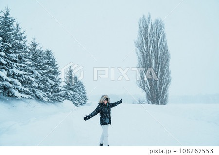 Woman tourist Visiting in Biei, Traveler in Sweater sightseeing Tree of Ken and Marry with Snow in winter season. landmark and popular for attractions in Hokkaido, Japan. Travel and Vacation concept 108267553