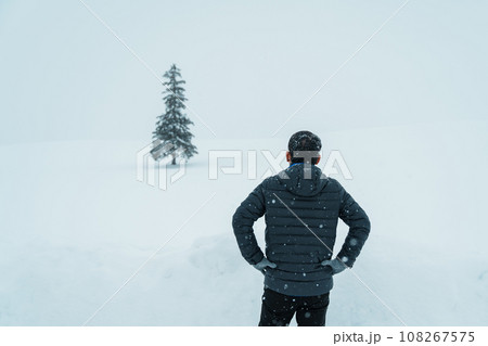 man tourist Visiting in Biei, Traveler in Sweater sightseeing Christmas tree with Snow in winter season. landmark and popular for attractions in Hokkaido, Japan. Travel and Vacation concept man tourist Visiting in Biei, Traveler in Sweater sightseeing Christmas tree with Snow in winter season. landmark and popular for attractions in Hokkaido, Japan. Travel and Vacation concept 108267575