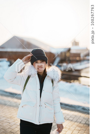 Woman tourist Visiting in Hakodate, Traveler in Sweater sightseeing Kanemori Red Brick Warehouse with Snow in winter. landmark and popular for attractions in Hokkaido,Japan.Travel and Vacation concept 108267763