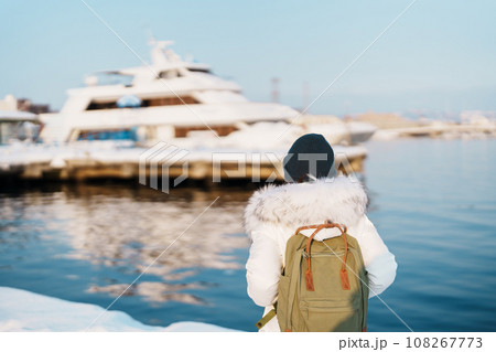 Woman tourist Visiting in Hakodate, Traveler in Sweater sightseeing Hakodate port near Red Brick Warehouse with Snow in winter. Hokkaido, Japan.Travel and Vacation concept Woman tourist Visiting in Hakodate, Traveler in Sweater sightseeing Hakodate port near Red Brick Warehouse with Snow in winter. Hokkaido, Japan.Travel and Vacation concept 108267773