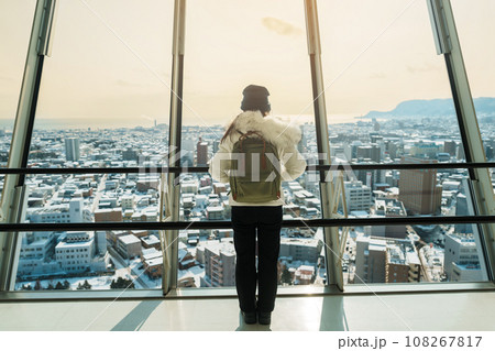 Woman tourist Visiting in Hakodate, Traveler in Sweater sightseeing view from Goryokaku Tower with Snow in winter. landmark and popular for attractions in Hokkaido, Japan.Travel and Vacation concept Woman tourist Visiting in Hakodate, Traveler in Sweater sightseeing view from Goryokaku Tower with Snow in winter. landmark and popular for attractions in Hokkaido, Japan.Travel and Vacation concept 108267817