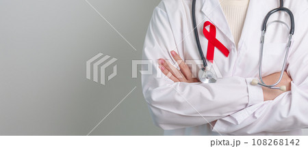 Doctor with Red Ribbon for December World Aids Day, acquired immune deficiency syndrome, multiple myeloma Cancer Awareness month and National Red ribbon week. Healthcare and world cancer day concept 108268142
