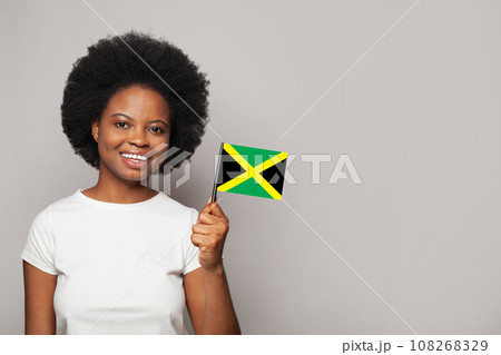 Jamaican woman holding flag of Jamaica Education, business, citizenship and patriotism concept Jamaican woman holding flag of Jamaica Education, business, citizenship and patriotism concept 108268329